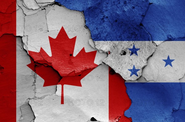 Flags of Canada and Honduras painted on cracked wall