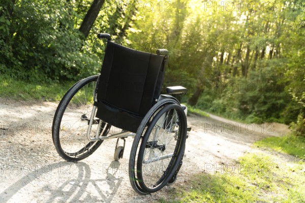 Photo of empty wheelchair parked in park, health care concept