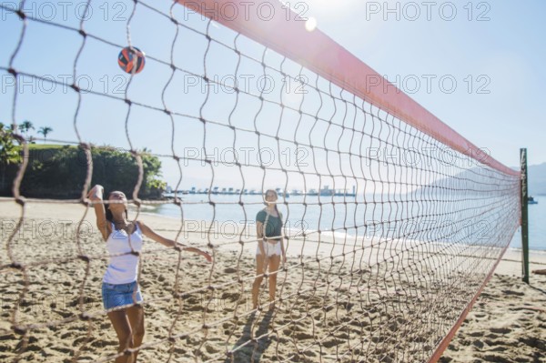 young girls playing volley beach