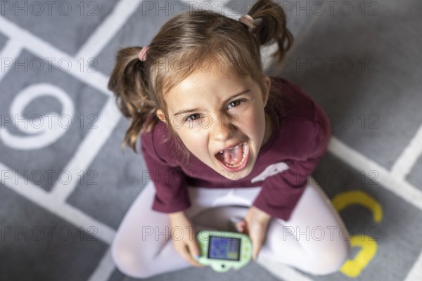 Portrait little girl upset because game