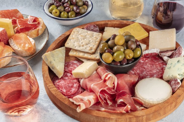 Italian antipasti or Spanish tapas with wine. Charcuterie platter with prosciutto, jamon, cheese,