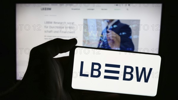 Stuttgart, Germany, 07-15-2024: Person holding mobile phone with logo of German company Landesbank