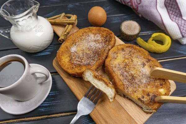 Top view of some torrijas with coffee, milk and elements for its elaboration