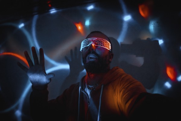 Bearded man wearing futuristic glasses interacting with virtual reality, moving hands and