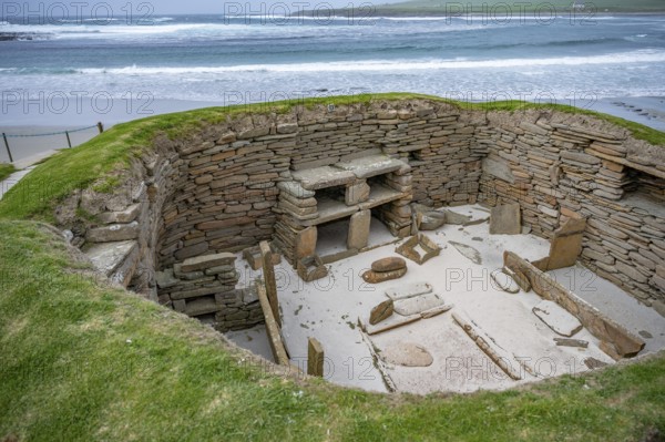 Skara Brae prehistoric village at Orkney Island, wide angle shot, sea in the background, Scotland,