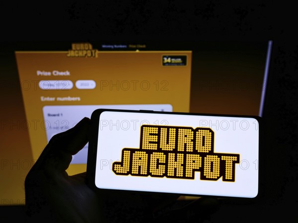 Stuttgart, Germany, 01-08-2022: Person holding mobile phone with logo of transnational European