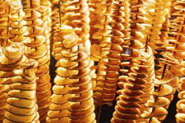 Spiralised potatoes on a wooden skewer at the Mercado de la Boqueria in Barcelona, Spain, Europe