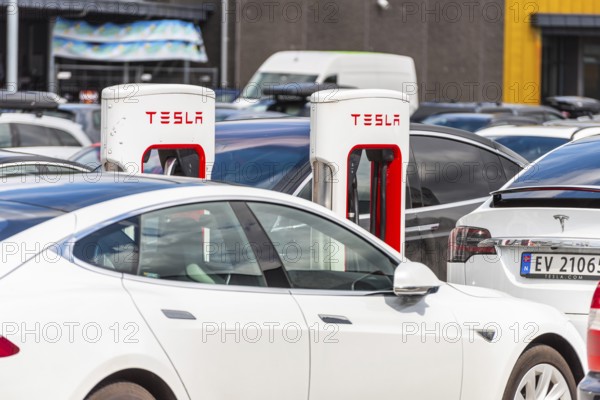 Lyngdal, Norway, August 02 2021: Electric cars charging at a Tesla supercharger, Europe