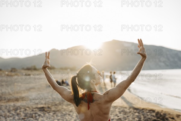 Woman relaxing in a bikini on the beach, Greece, Europe