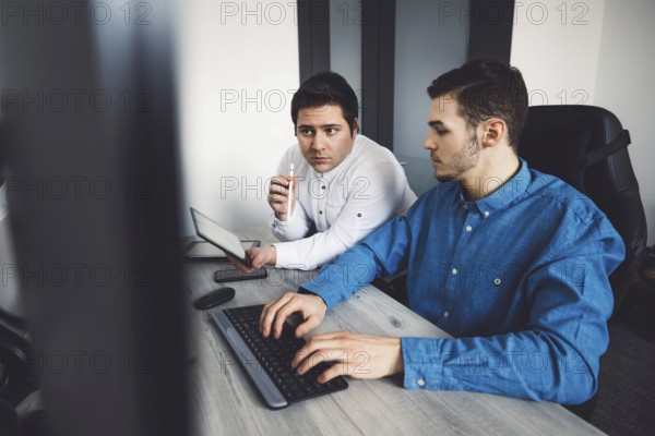 IT Programmer Working on Desktop Computer. Male Specialist Creating Innovative Software Engineer