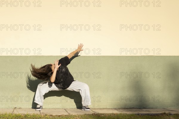 Tennage girl dancing on the street. Copy space