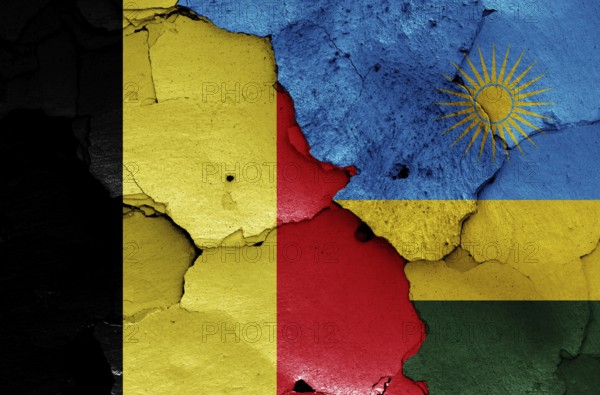Flags of Belgium and Rwanda painted on cracked wall