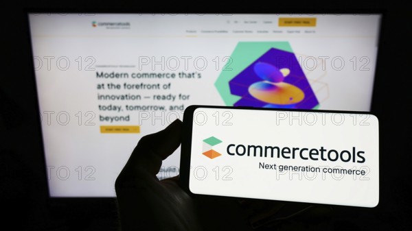 Stuttgart, Germany, 03-30-2022: Person holding cellphone with logo of German e-commerce company