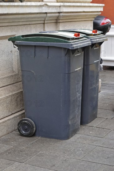 Two garbage wheelie bins at street