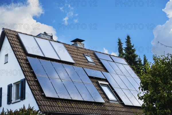 Solar panels and solar thermal energy on the roof of a detached house in Essen, Germany, Europe