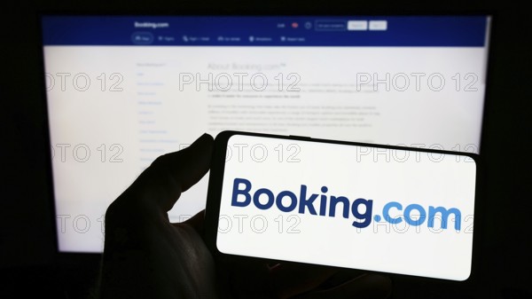 Stuttgart, Germany, 10-24-2022: Person holding smartphone with logo of Dutch online travel agency