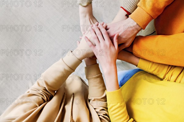 Pile of hands of friends. Teenagers putting their hands together. Close up