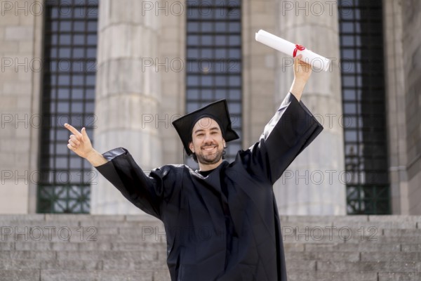 Confident man in graduation outfit, male obtaining degree, academic career
