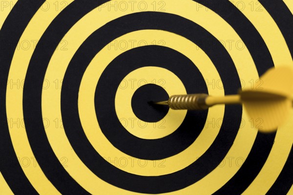 Close up dartboard center with arrow