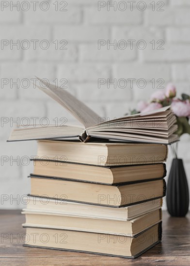 Arrangement with books stack indoors