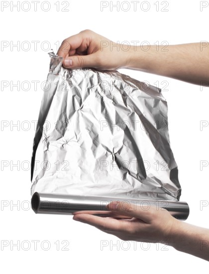 Man holding a roll of household aluminum foil