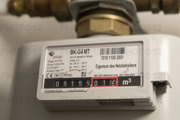 Symbolic image of energy costs in the household, natural gas, analogue gas meter in a flat,
