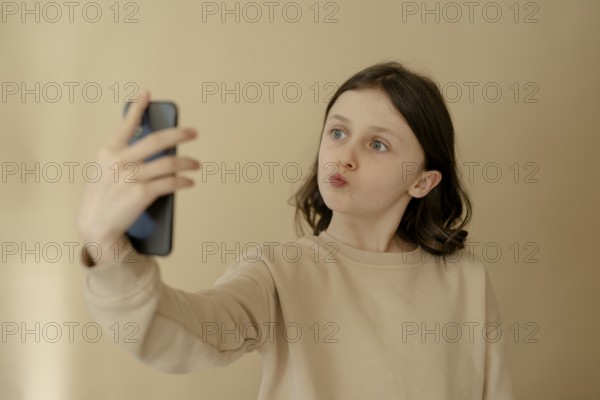 Girl, 10, takes a selfie with mobile phone
