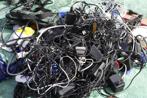 Battery charger and wires mess in second hand market tech trash