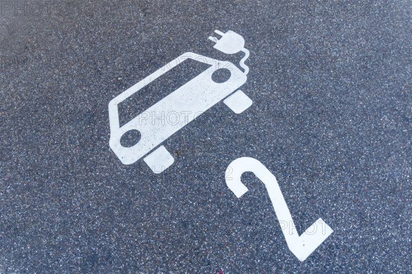 parking lot for electric cars, pictogram of a car with a plug and number 2 on the floor