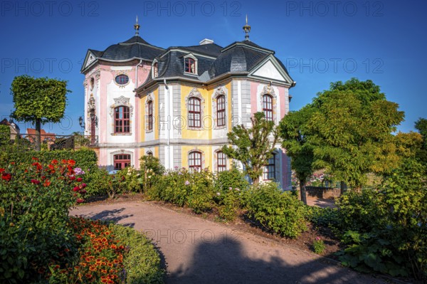 The beautiful rococo castle of the Dornburg Castles with lush gardens and well-tended shrubs under