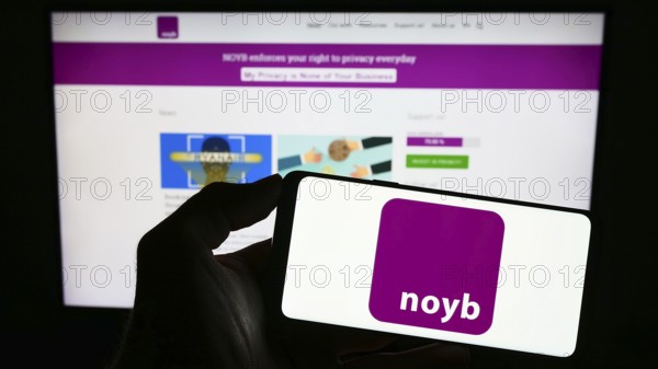 Stuttgart, Germany, 07-31-2023: Person holding mobile phone with logo of NOYB ? European Center for