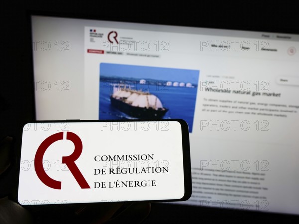 Stuttgart, Germany, 08-27-2022: Person holding cellphone with logo of French Commission de