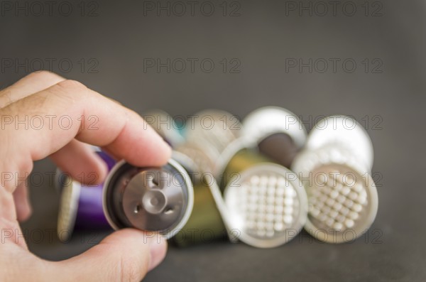 Colorful espresso coffee capsules used on black background, recycling, environment
