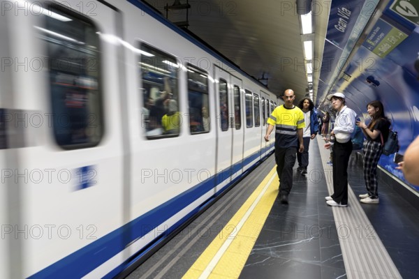 At Almudena Madrid's Puerta de Atocha?Almudena Grandes station, commuters await trains amidst