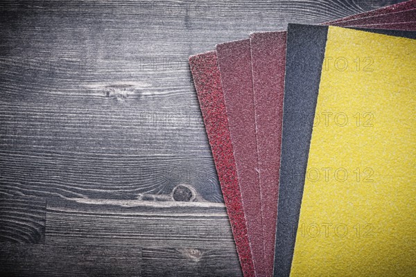 Sandpaper on old wooden board Sanding tools
