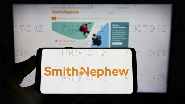 Stuttgart, Germany, 05-29-2022: Person holding cellphone with logo of medical equipment company