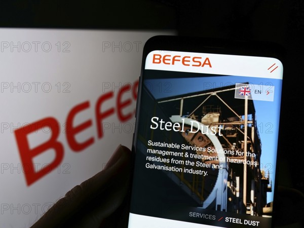 Stuttgart, Germany, 05-21-2022: Person holding cellphone with webpage of recycling company Befesa