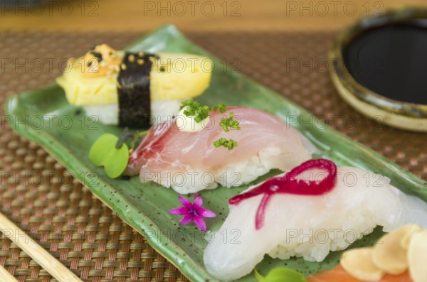 Platter with different types of nigirizushi, nigiri with different fish and one decorated with a
