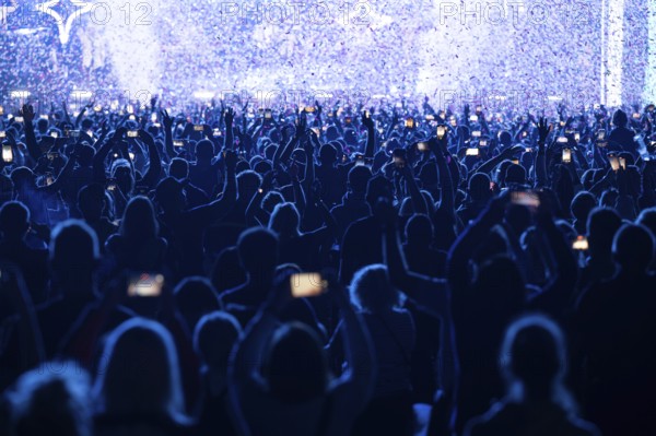 Crowd of people in front of the stage during the concert.