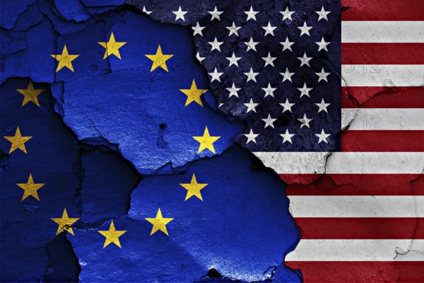 Flags of EU and USA painted on cracked wall