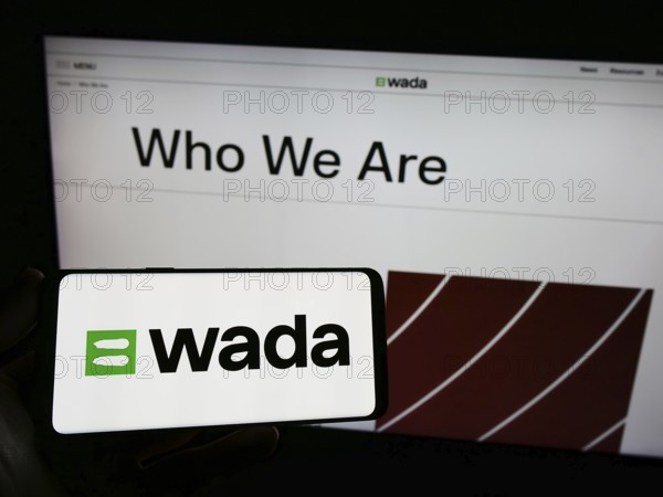 Stuttgart, Germany, 07-09-2023: Person holding smartphone with logo of organization World