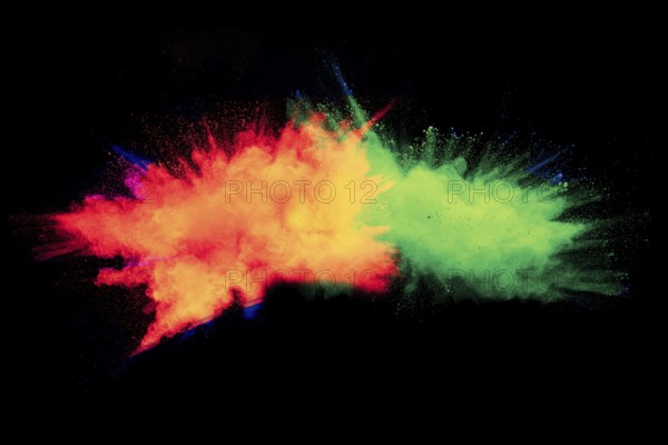 Abstract color powder explosion on black background.Freeze motion of dust splash. Painted Holi in