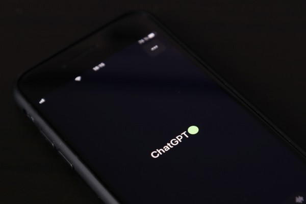Symbolic image artificial intelligence, detailed view of a smartphone with the app ChatGPT,