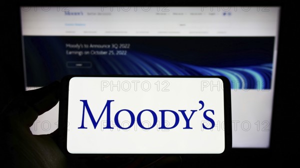 Stuttgart, Germany, 10-09-2022: Person holding cellphone with logo of rating company Moody's