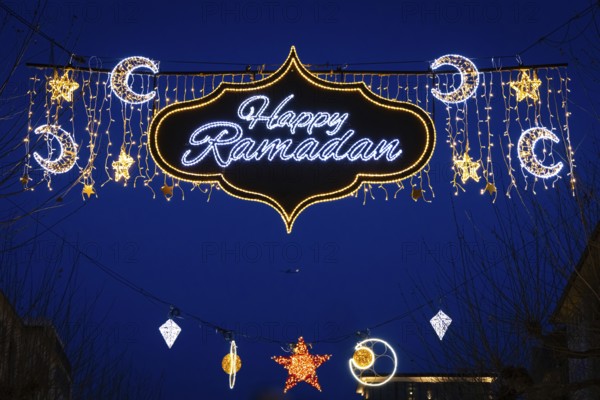 The illuminated lettering Happy Ramadan shines on the evening of 10 March 2024 as part of a light