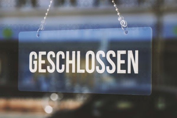 sign geschlossen - closed in german - economy crisis or business closure concept