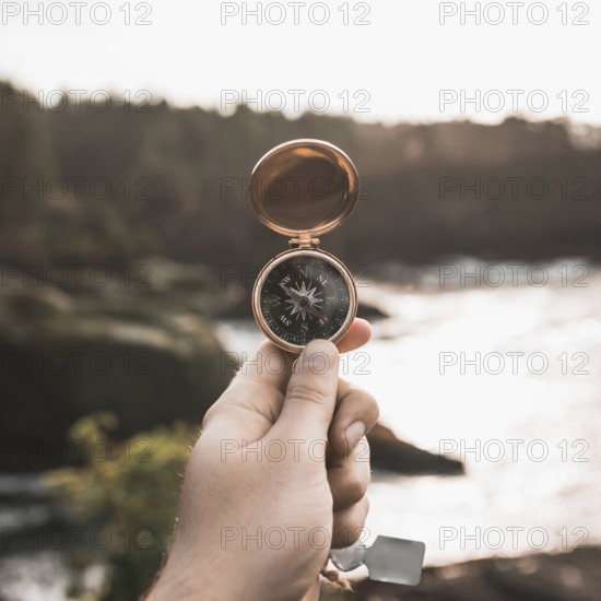 Crop hand with vintage compass