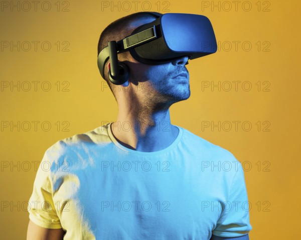 Medium shot man wearing virtual reality gadget