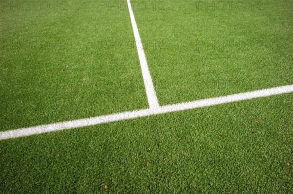 Detail of a football pitch with clear marking lines on green artificial turf, Bottrop, North
