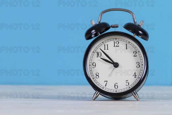 Close up alarm clock with blue background